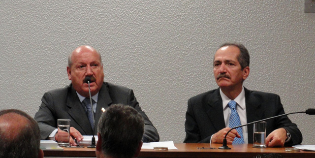 O relator Luiz Henrique lê seu parecer ao lado de Aldo Rebelo, convidado à mesa. Foto: Nathália Clark